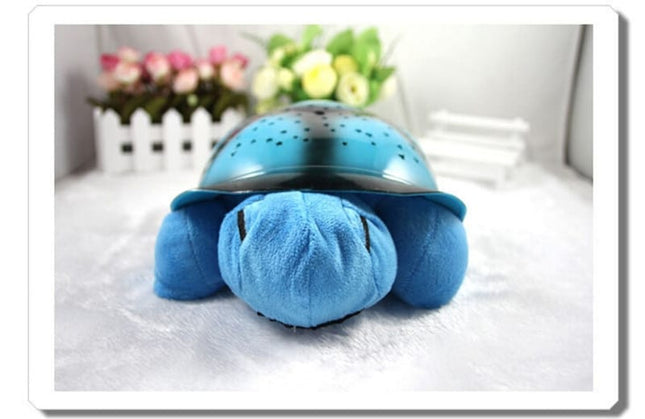 Peluche tortuga proyector de estrellas musical