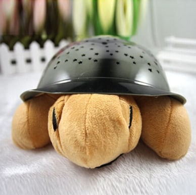 Peluche tortuga proyector de estrellas musical